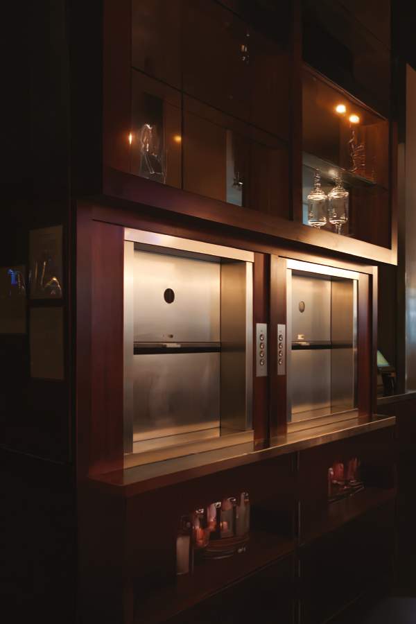 Interior view of a compact dumbwaiter elevator cabin designed for small loads and smooth vertical transportation.